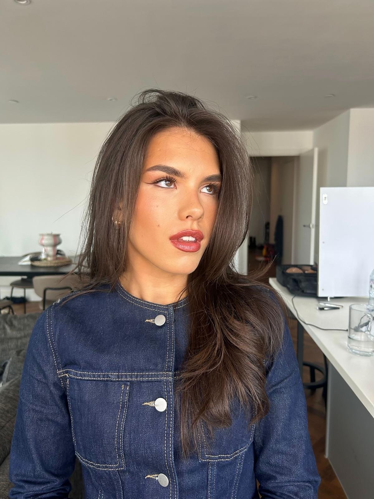 Occasion makeup look: client with long brunette hair, a soft winged liner and a red lip